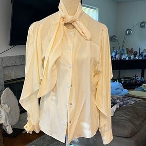 Elegant Cream Button-Up Blouse With Bottom Cutout Sleeves.
